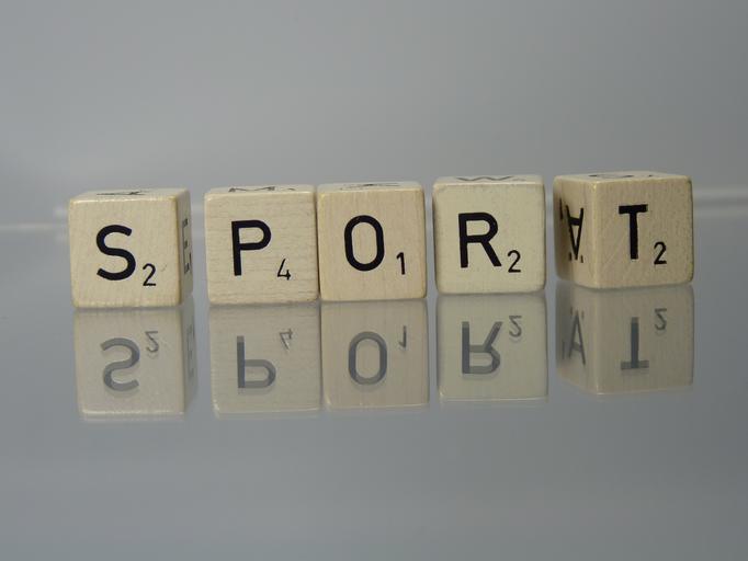Scrabble tiles spelling out SPORT.